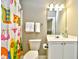 Cozy bathroom featuring a bright shower curtain, white vanity and toilet, and well-lit mirror at 5801 Oyster Catcher Dr. # 832, North Myrtle Beach, SC 29582