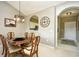 Cozy dining room featuring a wooden table with six chairs and modern chandelier at 5801 Oyster Catcher Dr. # 832, North Myrtle Beach, SC 29582