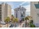 A building with balconies, parking, and palm trees adds a coastal charm to the surroundings at 5801 Oyster Catcher Dr. # 832, North Myrtle Beach, SC 29582