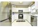 Bright kitchen with white cabinets, stainless steel appliances, and tile flooring at 5801 Oyster Catcher Dr. # 832, North Myrtle Beach, SC 29582