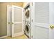 Laundry closet featuring a stacked washer and dryer with white bi-fold doors at 5801 Oyster Catcher Dr. # 832, North Myrtle Beach, SC 29582