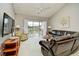 Well-lit living room features comfortable seating and balcony access at 5801 Oyster Catcher Dr. # 832, North Myrtle Beach, SC 29582