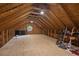Spacious unfinished attic featuring wood beams, a round window, and plenty of room for storage or customization at 5904 Bridlewood Rd., North Myrtle Beach, SC 29582