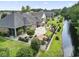 Backyard featuring a stone patio, manicured garden beds, fenced yard, and waterfront view at 5904 Bridlewood Rd., North Myrtle Beach, SC 29582