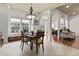 Elegant dining room with chandelier, large windows, and access to multiple living areas at 5904 Bridlewood Rd., North Myrtle Beach, SC 29582