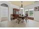 Traditional dining room featuring a chandelier, display cabinet, and natural light from large windows at 5904 Bridlewood Rd., North Myrtle Beach, SC 29582