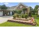 Landscaped front yard with brick borders, decorative shrubbery, and a Maryland state flag at 5904 Bridlewood Rd., North Myrtle Beach, SC 29582