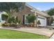 Brick home with manicured landscaping, including flower pots and a decorative stone at 5904 Bridlewood Rd., North Myrtle Beach, SC 29582