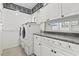 Functional laundry room with ample cabinet space, granite countertops and appliances at 5904 Bridlewood Rd., North Myrtle Beach, SC 29582
