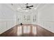 Bright and spacious living room with hardwood floors, tray ceiling, and plantation shutters at 5904 Bridlewood Rd., North Myrtle Beach, SC 29582