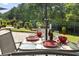 Outdoor dining set on a brick patio, perfect for enjoying meals in a serene backyard setting at 5904 Bridlewood Rd., North Myrtle Beach, SC 29582