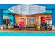 The Quarterdeck Restaurant bartender stands behind the bar with drinks menu at 5905 S Kings Hwy. # 416 A, Myrtle Beach, SC 29575