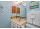 Coastal bathroom with vanity sink, wood shutter accents and blue painted walls at 5905 S Kings Hwy. # 416 A, Myrtle Beach, SC 29575