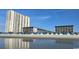 Beautiful beach view with high-rise buildings and blue umbrellas in Myrtle Beach Resort at 5905 S Kings Hwy. # 416 A, Myrtle Beach, SC 29575