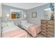 Cozy bedroom featuring two beds, matching nightstand, dresser, mirror and light blue walls at 5905 S Kings Hwy. # 416 A, Myrtle Beach, SC 29575