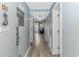 Hallway to condo with gray walls, wood-style flooring, and white trim that leads to the living area at 5905 S Kings Hwy. # 416 A, Myrtle Beach, SC 29575