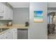 Kitchen with stainless steel dishwasher, white cabinets, and beach-themed decor at 5905 S Kings Hwy. # 416 A, Myrtle Beach, SC 29575