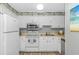 Kitchen area with white appliances, cabinets and backsplash with views to the dining area at 5905 S Kings Hwy. # 416 A, Myrtle Beach, SC 29575