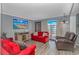 Living room with red couches, wood floors, TV, and balcony access with ocean views at 5905 S Kings Hwy. # 416 A, Myrtle Beach, SC 29575
