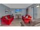 Comfortable living room features red couches, TV, wood floors, and balcony access at 5905 S Kings Hwy. # 416 A, Myrtle Beach, SC 29575