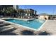 Outdoor pool with lounge chairs at Myrtle Beach Resort with a building and palms in the background at 5905 S Kings Hwy. # 416 A, Myrtle Beach, SC 29575