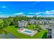 Aerial view of community with a swimming pool, clubhouse, and surrounding greenery at 650 Tupelo Ln. # 5-F, Longs, SC 29568