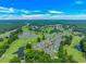 Aerial view showcases the community's landscaping, golf course, lake, and surrounding nature at 650 Tupelo Ln. # 5-F, Longs, SC 29568
