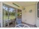 Cozy outdoor patio complete with a table, chairs, and view to the green landscape at 650 Tupelo Ln. # 5-F, Longs, SC 29568