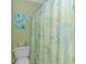 Cozy bathroom featuring a toilet and a decorative shower curtain at 650 Tupelo Ln. # 5-F, Longs, SC 29568