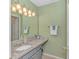Bathroom with a granite countertop and a well-lit mirror at 650 Tupelo Ln. # 5-F, Longs, SC 29568
