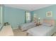 This bedroom offers twin beds, natural light, and calming neutral tones, creating a cozy and inviting space at 650 Tupelo Ln. # 5-F, Longs, SC 29568