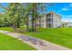 Exterior view of condo buildings with screened-in balconies and lush landscaping at 650 Tupelo Ln. # 5-F, Longs, SC 29568