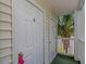 Condo doorways show entrances to residences on a balcony with a palm tree in the background at 650 Tupelo Ln. # 5-F, Longs, SC 29568