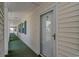 Exterior hallway featuring a door, green outdoor carpet, and green shutters at 650 Tupelo Ln. # 5-F, Longs, SC 29568