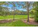 Relaxing green view of the lush golf course featuring a paved path and two golf carts at 650 Tupelo Ln. # 5-F, Longs, SC 29568