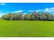 Expansive green lawn with mature trees in the distance offers a serene view at 650 Tupelo Ln. # 5-F, Longs, SC 29568