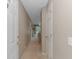 Long hallway with neutral walls, carpet flooring, and access to rooms, leading to an outdoor balcony at 650 Tupelo Ln. # 5-F, Longs, SC 29568