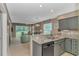 Kitchen with granite countertop, gray cabinets, and open view to the living room and porch at 650 Tupelo Ln. # 5-F, Longs, SC 29568