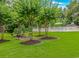 Relaxing picnic area with tables and grills nestled among lush green trees and landscaping at 650 Tupelo Ln. # 5-F, Longs, SC 29568