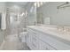 Bright bathroom featuring double sinks, a marble countertop, and a glass-enclosed tiled shower at 6624 Lagoon Pl., Myrtle Beach, SC 29572