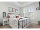 Comfortable bedroom with natural light, stylish decor, and a cozy bed with unique patterned bedding at 6624 Lagoon Pl., Myrtle Beach, SC 29572