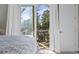 Comfortable bedroom featuring a private balcony overlooking a serene lake and lush greenery at 6624 Lagoon Pl., Myrtle Beach, SC 29572