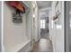 Inviting entryway with coat rack, bench, and a glimpse of the stylish bedroom and bath at 6624 Lagoon Pl., Myrtle Beach, SC 29572