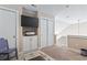 Upstairs landing featuring a TV, storage cabinets, and a comfortable chair at 6624 Lagoon Pl., Myrtle Beach, SC 29572