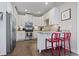 Well-lit kitchen featuring updated appliances, tiled backsplash and breakfast bar with seating at 6624 Lagoon Pl., Myrtle Beach, SC 29572