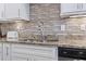 Close up on a kitchen sink, granite countertops and a stainless steel faucet at 6624 Lagoon Pl., Myrtle Beach, SC 29572