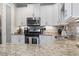 Bright kitchen featuring stainless steel appliances, white cabinets and stone countertops at 6624 Lagoon Pl., Myrtle Beach, SC 29572