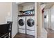 Modern laundry room features washer and dryer with sleek cabinets for storage at 6624 Lagoon Pl., Myrtle Beach, SC 29572