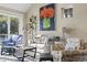 Bright living room with a comfortable seating area, large art piece, and lots of natural light at 6624 Lagoon Pl., Myrtle Beach, SC 29572
