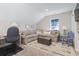 Comfortable living room with neutral walls, a large sectional, an ottoman, and a desk at 6624 Lagoon Pl., Myrtle Beach, SC 29572